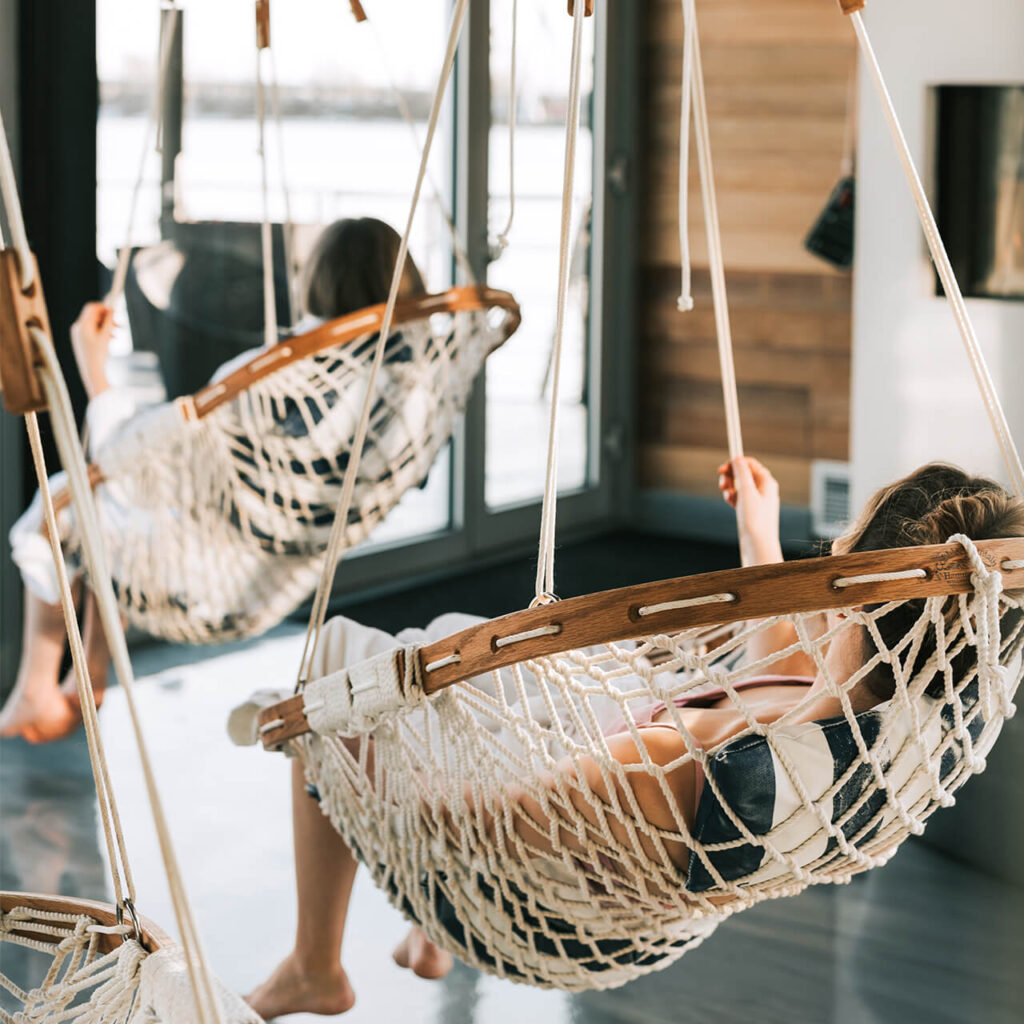 Two individuals lounging in Cobble Mountain Original Hammock Chairs.