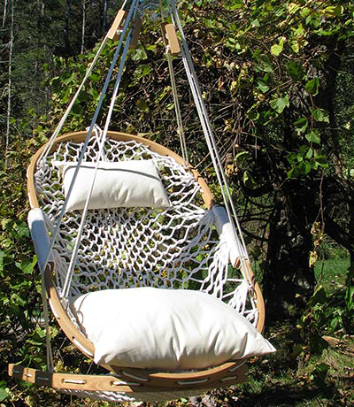 Hanging chair with oak frame and a soft woven hammock seat