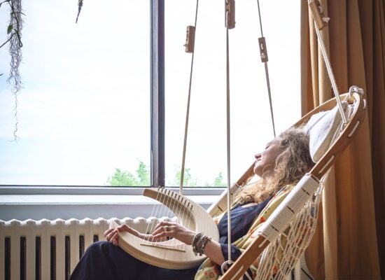 woman relaxing in hammock chair, self-care