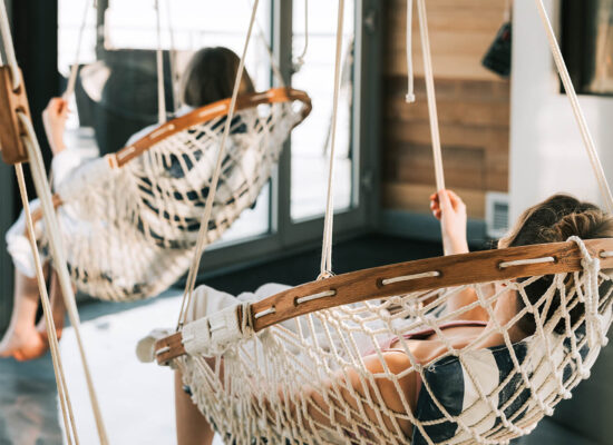 Ladies relaxing in two Suspended Hammock Chairs