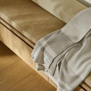 Sunbrella Veranda Stripe throw adding modern comfort to an indoor living space.